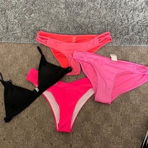 Pink swimming suit bottoms and one black top